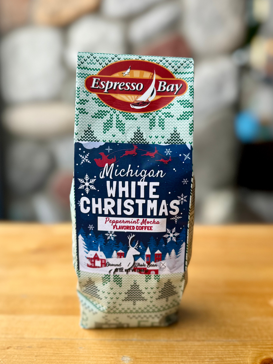 Espresso Bay Michigan White Christmas coffee package on a wooden surface with a blurred background